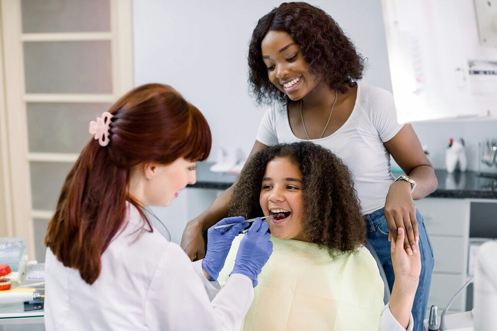 Patient receiving a routine dental examination for early cavity detection